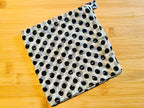 Black and white polka dot towel on a wooden surface