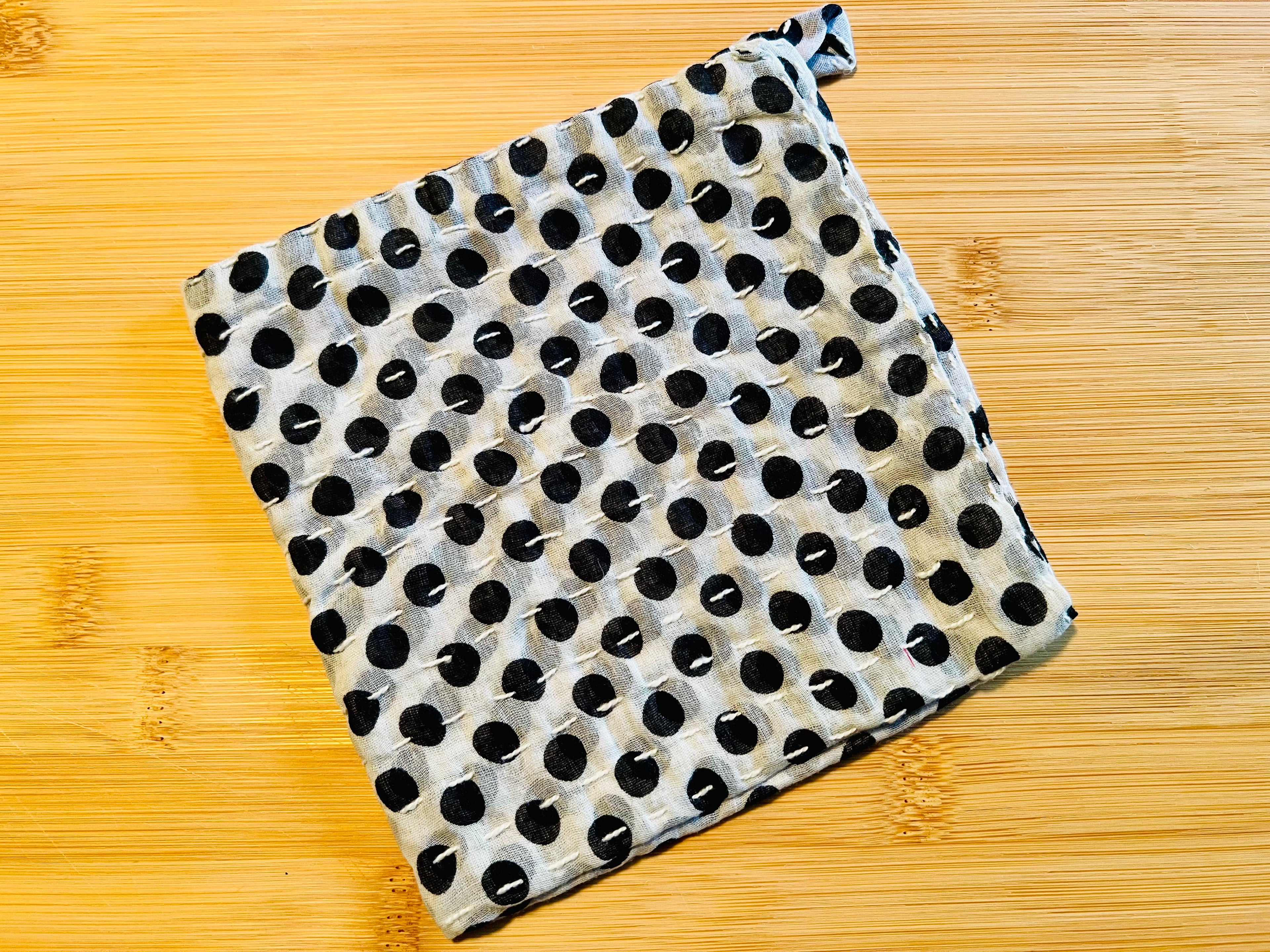 Black and white polka dot towel on a wooden surface