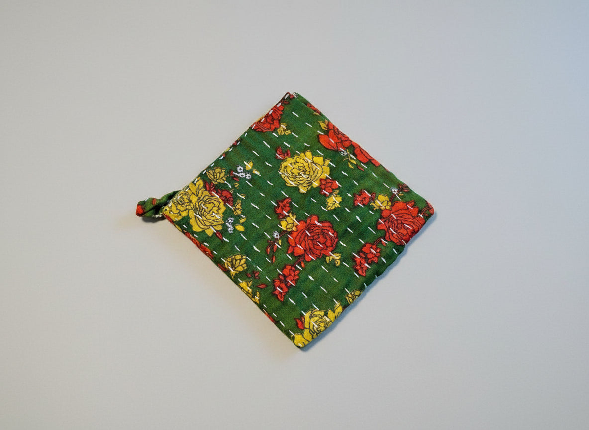 A bright and colorful Kantha dish cloth with floral designs.