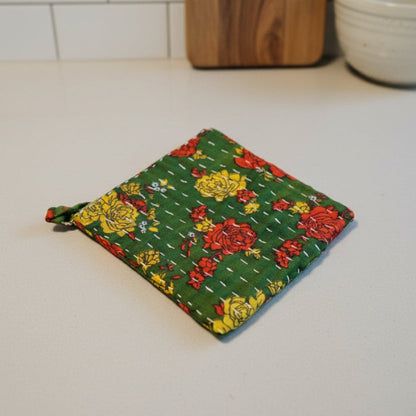 A bright and colorful Kantha dish cloth with floral designs.