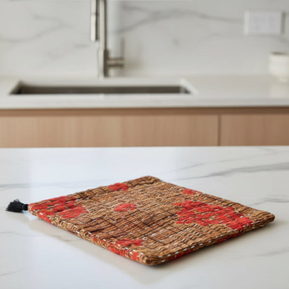 Textile product with red floral patterns on a brown background