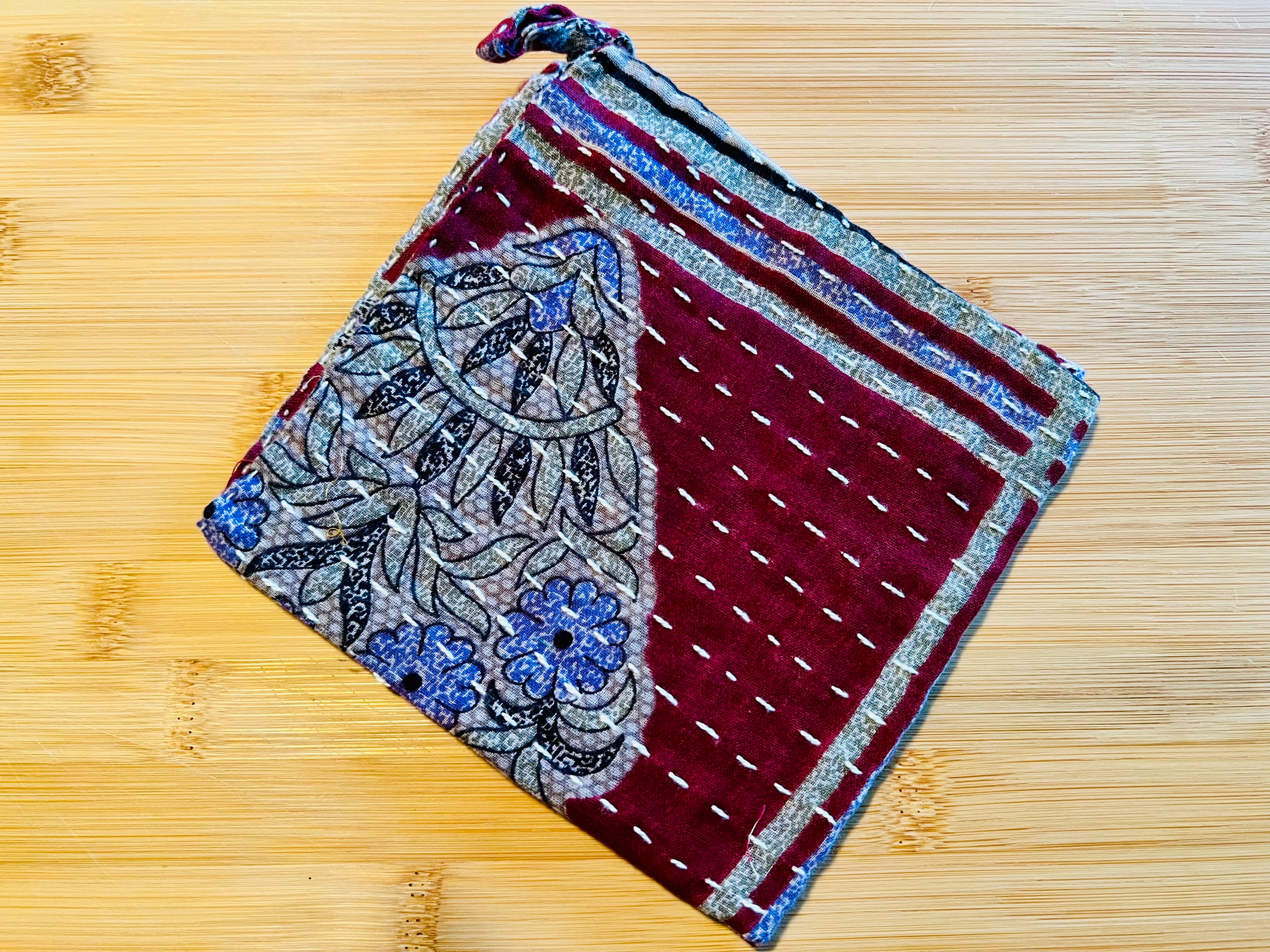 Decorative kitchen towel with floral pattern on a wooden surface