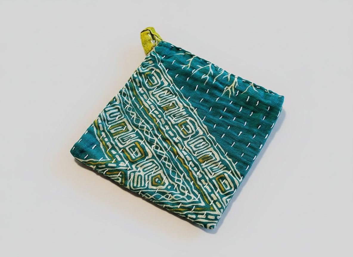 Geometric print green Kantha dish cloth with yellow and white designs.
