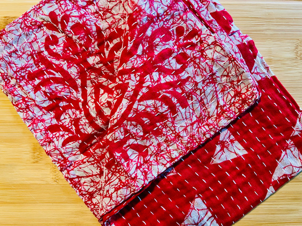Red and white patterned towel on a wooden surface