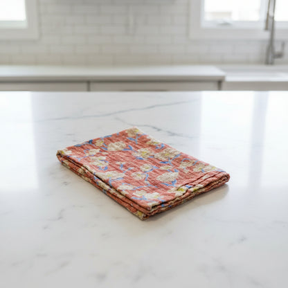 A soft floral patterned Kantha kitchen towel on a white background. 