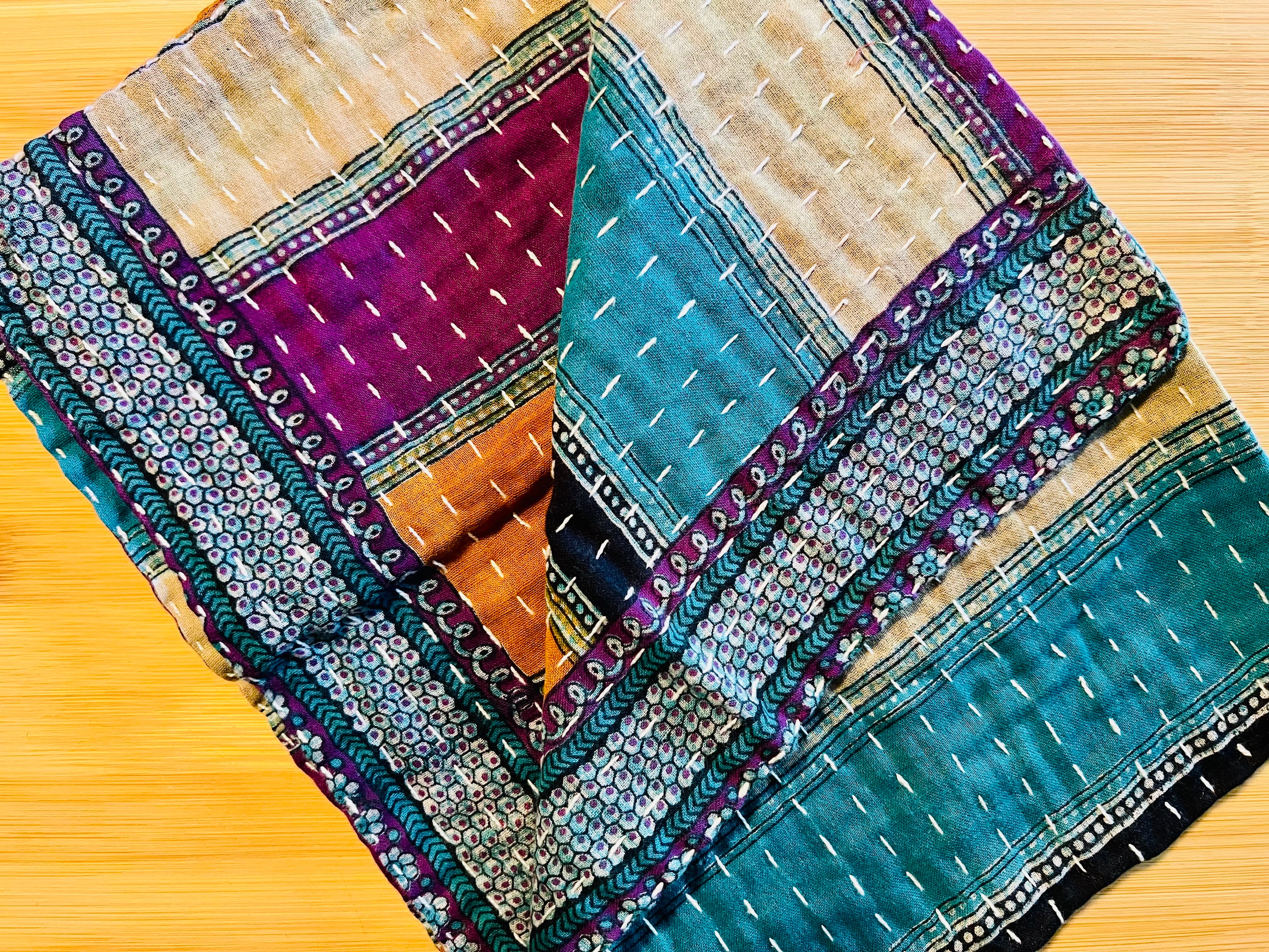 Colorful kitchen towel with geometric patterns on a wooden surface