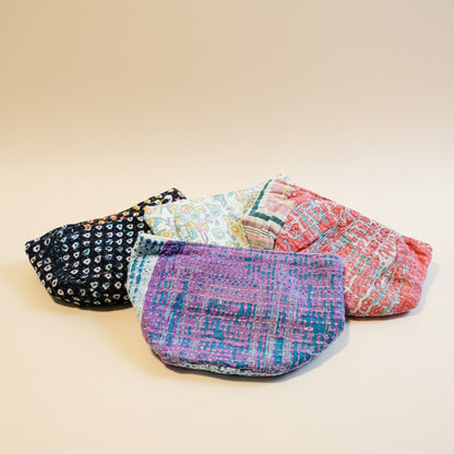 A colorful variety of Kantha baskets displayed on a gray background.
