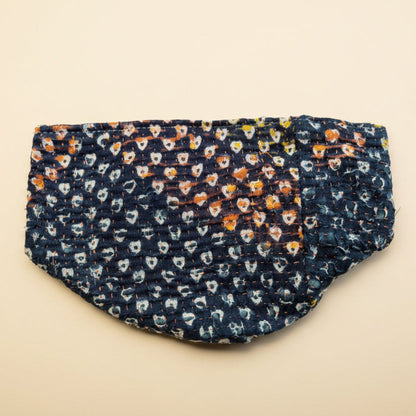 A beautiful heart patterned Kantha basket in various colors on a neutral background.
