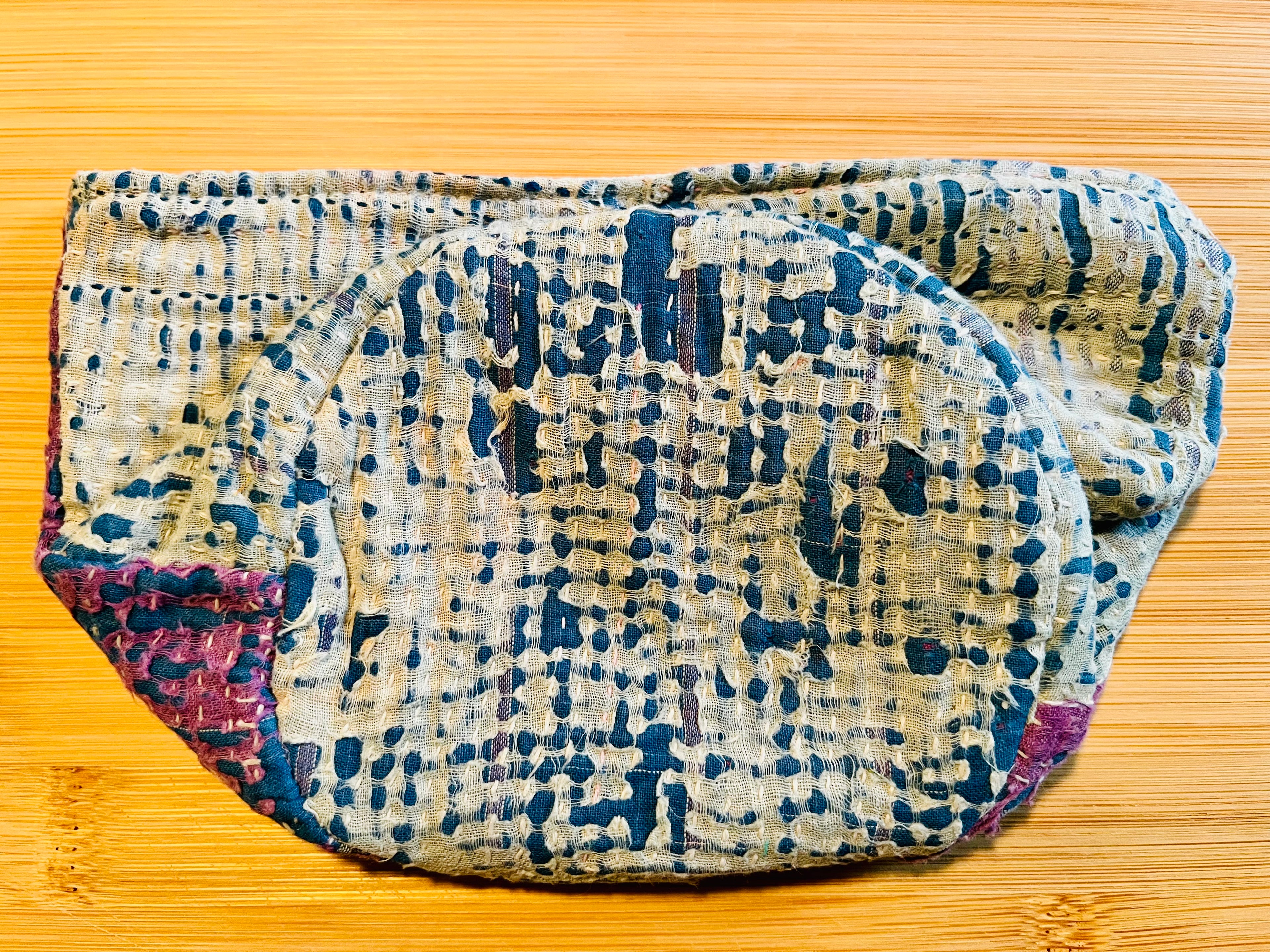 Blue, Purple, and White patterned fabric on a wooden surface