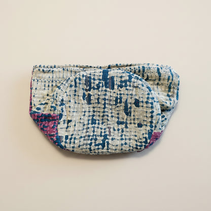 Multicolor Kantha basket in various colors and textures of fabrics on a neutral background.
