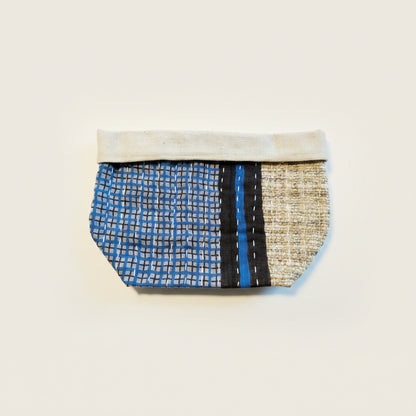 Geometric patterned black, blue, and white Kantha basket on a neutral background.