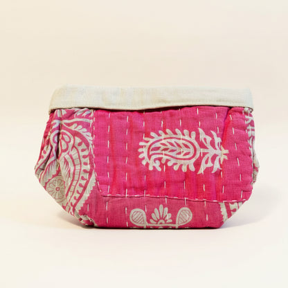 Pink and floral Kantha basket on a neutral background.