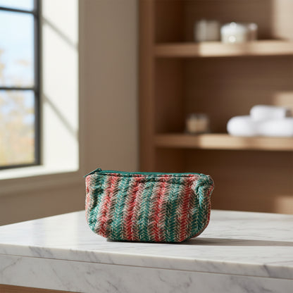 Herringbone design Kantha cosmetic zippered pouch made from artisans is featured on a neutral background.