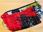 Colorful fabric pouch with a geometric pattern on a wooden surface