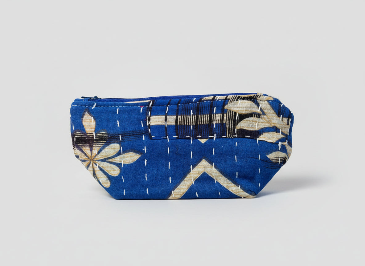 An abstract Kantha cosmetic bag with a blue and black floral design on a neutral background.