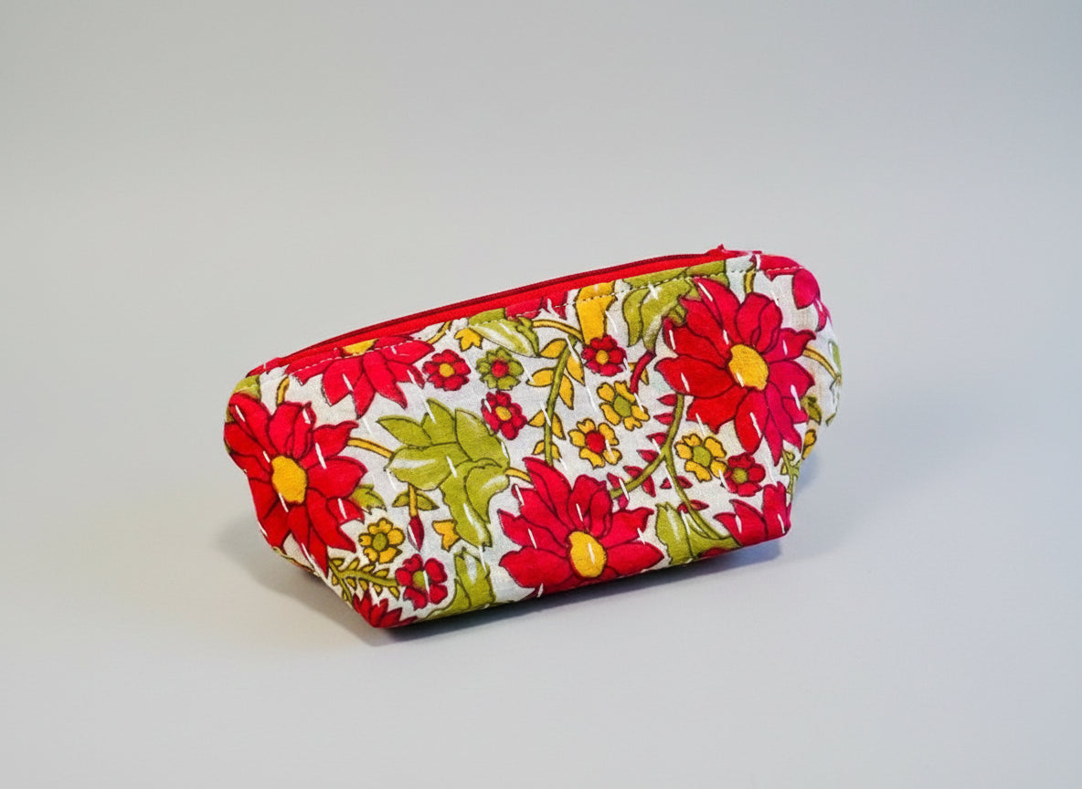 A bright floral Kantha cosmetic bag on a neutral background.