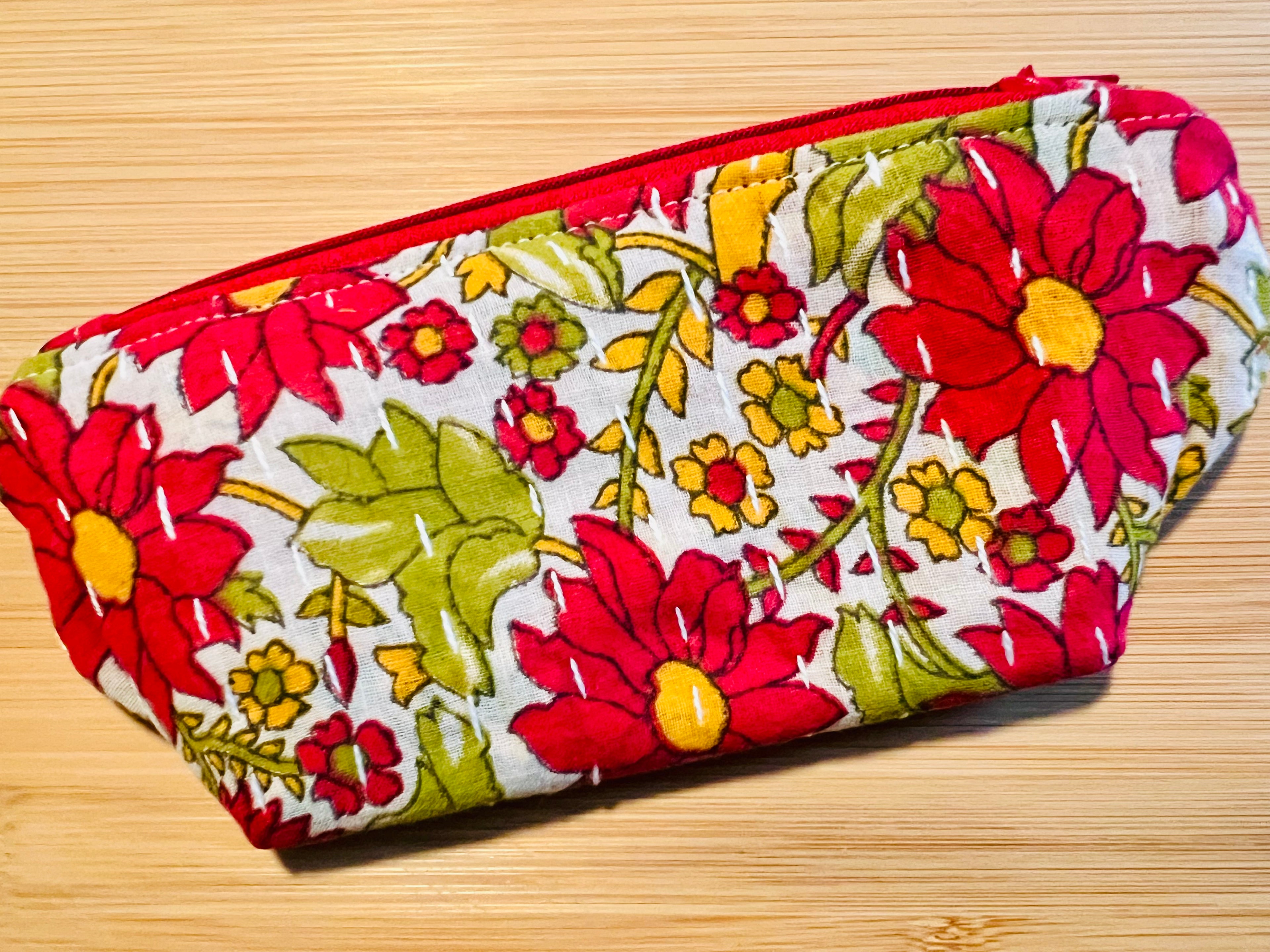 Bright red and yellow print on a small cosmetic bag from Rochambeau Home