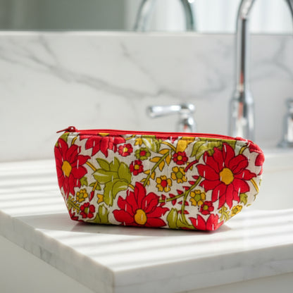 A bright floral Kantha cosmetic bag on a neutral background.
