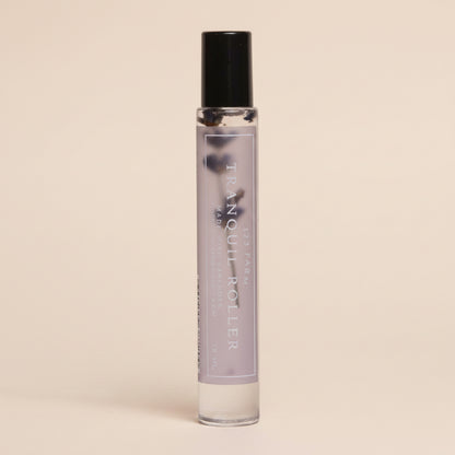 Small lavender glass roller bottle with black cap on a light gray background