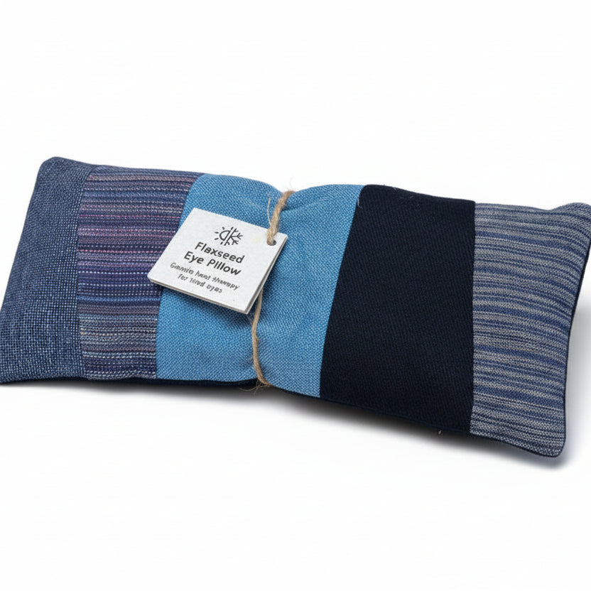 Blue and black flaxseed eye pillow with a label on a white background.