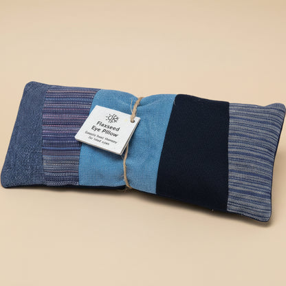Blue and black flaxseed eye pillow with a label on a white background.
