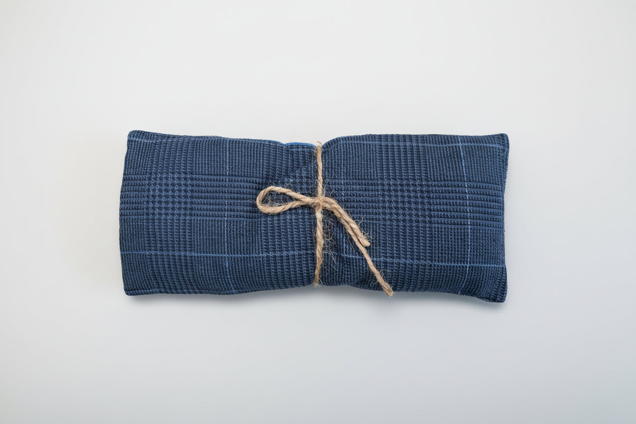 Blue woven pouch tied with string on a white background.