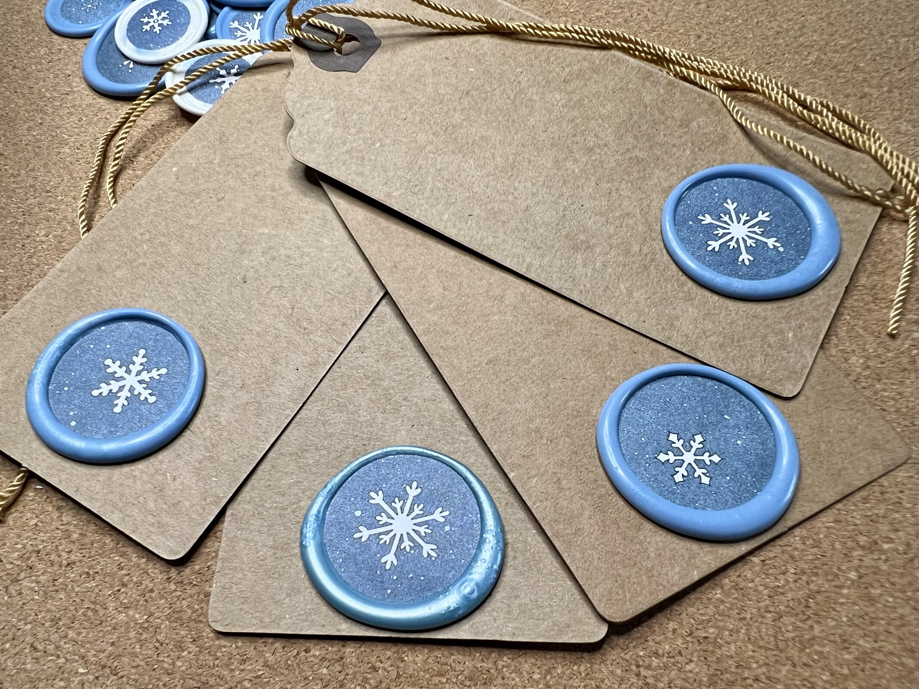 Set of four kraft gift tags topped with shimmering snowflake wax seals
