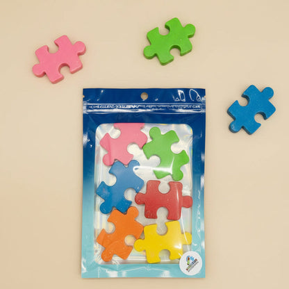 Colorful puzzle-piece repurposed crayons created by Spectrum Color Creations on a white background