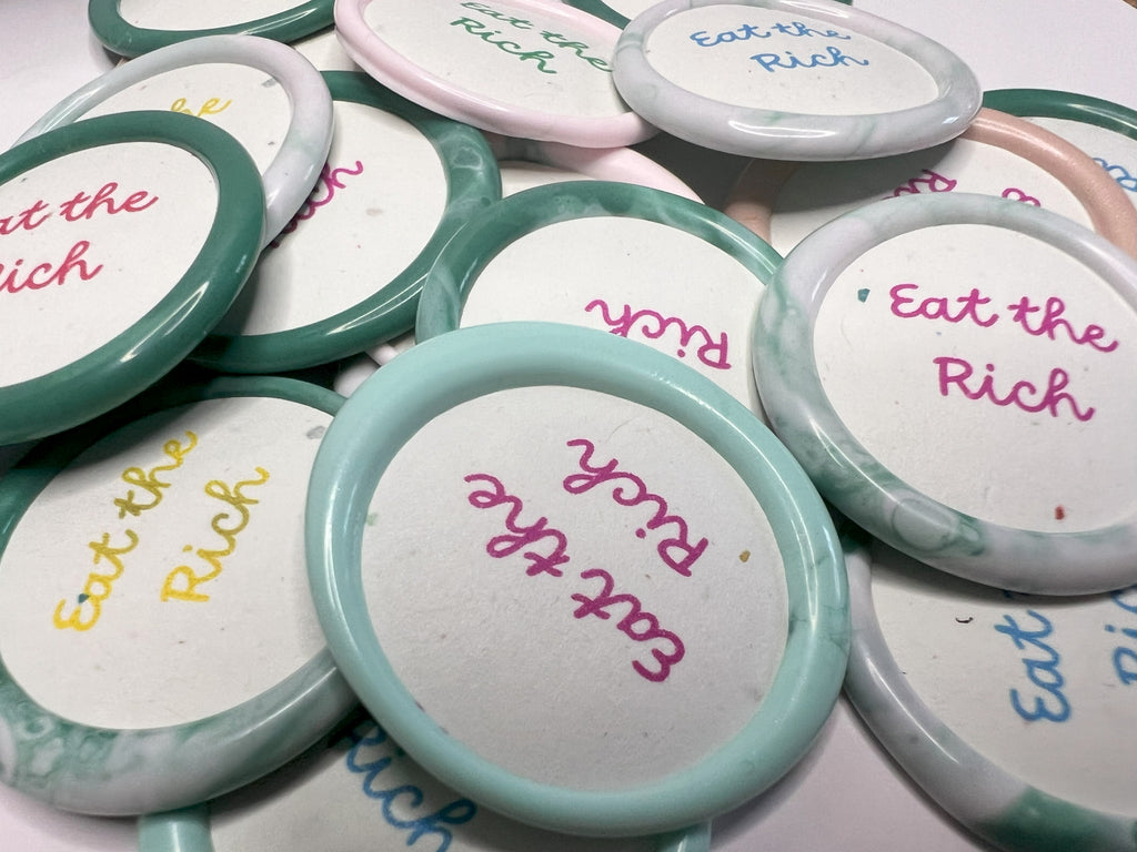 Bold wax seal sticker with “Eat the Rich” text in a vintage-style design for rebellious expression.