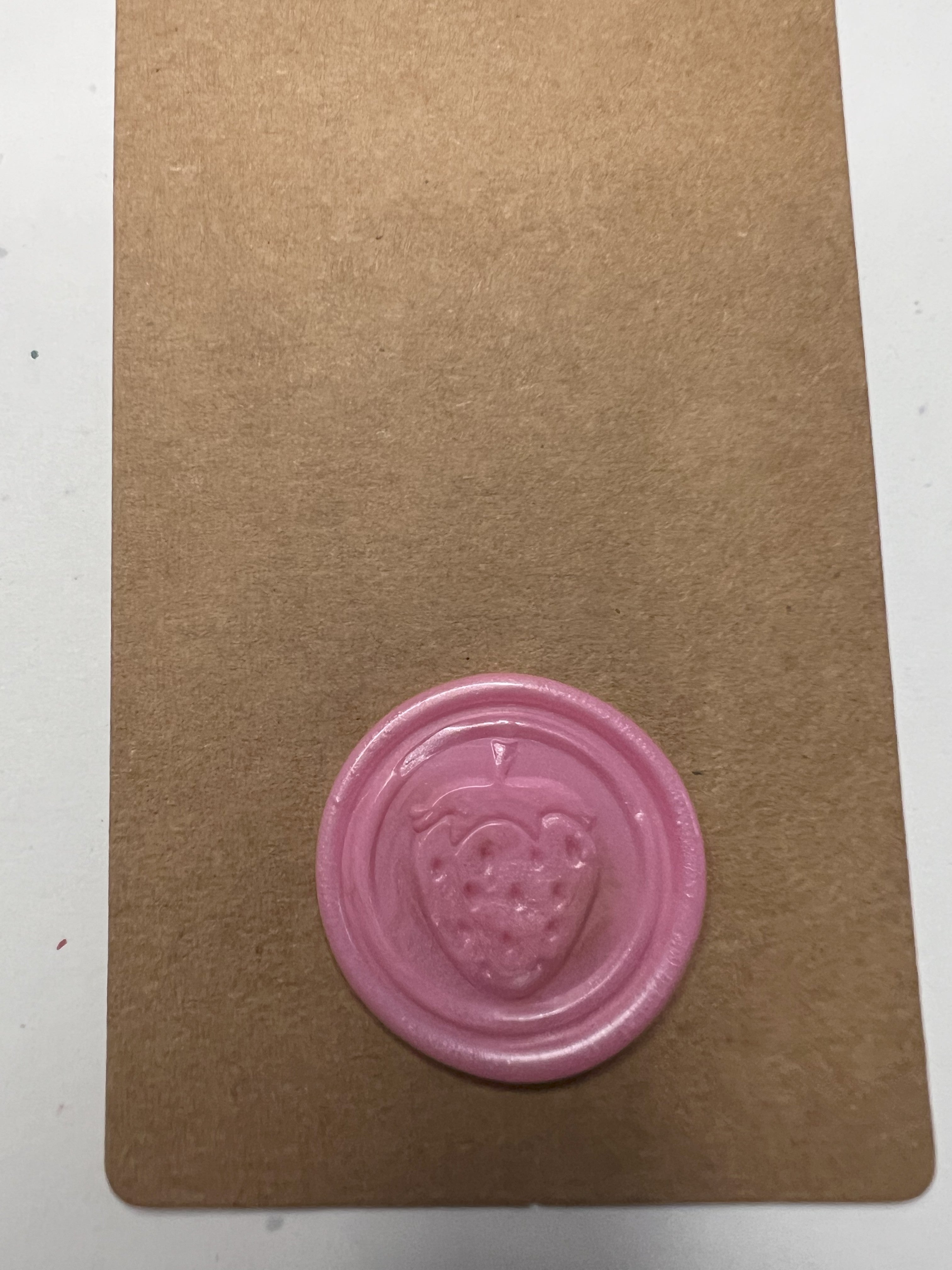 Handmade strawberry wax seals paired with natural twine and kraft tags for charm.