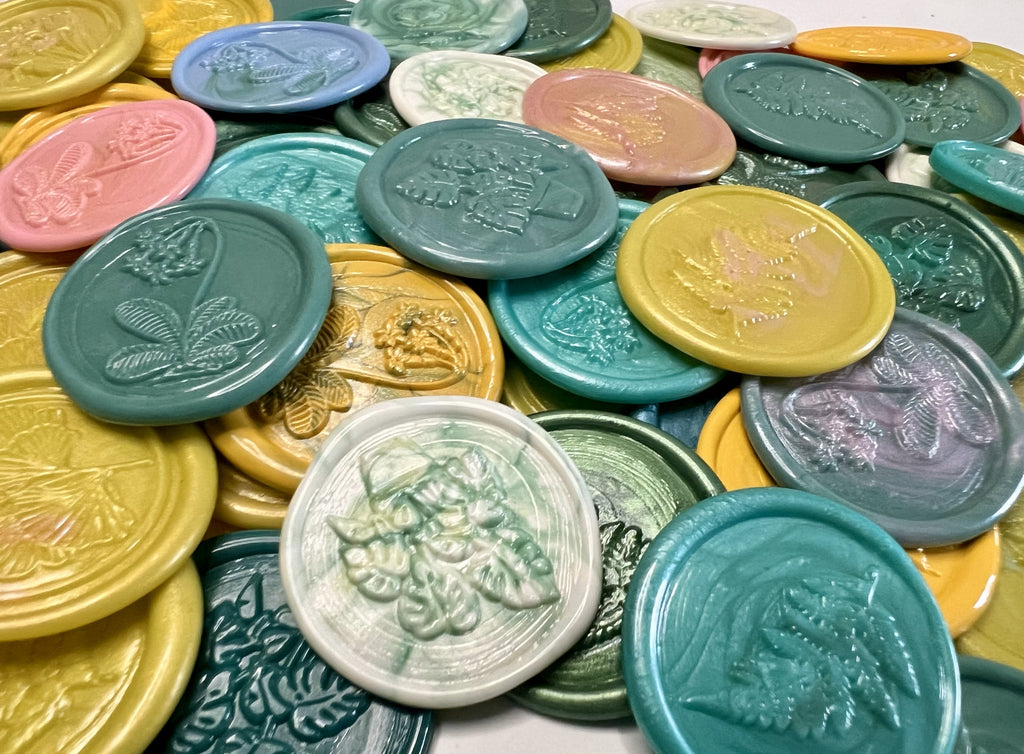 Vintage-style wax seals in floral shapes styled for a garden party or spring wedding
