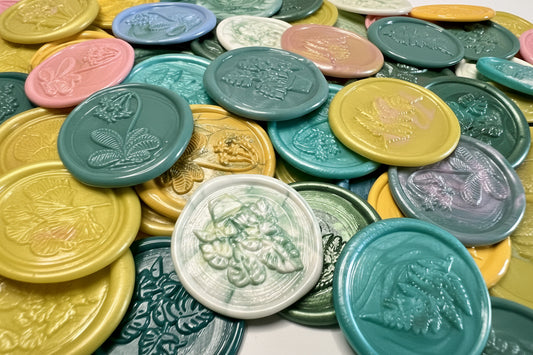 Vintage-style wax seals in floral shapes styled for a garden party or spring wedding