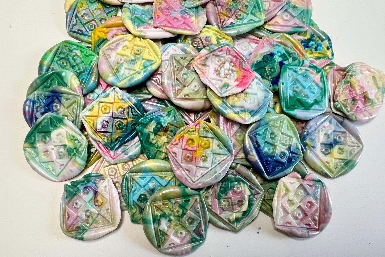Repurposed wax into beauty - Rochambeau Home's Rainbow Dot wax seal stickers in a rainbow swirl of color and embossed with a floral quilt seal.