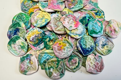 Repurposed wax into beauty - Rochambeau Home's Rainbow Dot wax seal stickers in a rainbow swirl of color and embossed with a floral quilt seal.