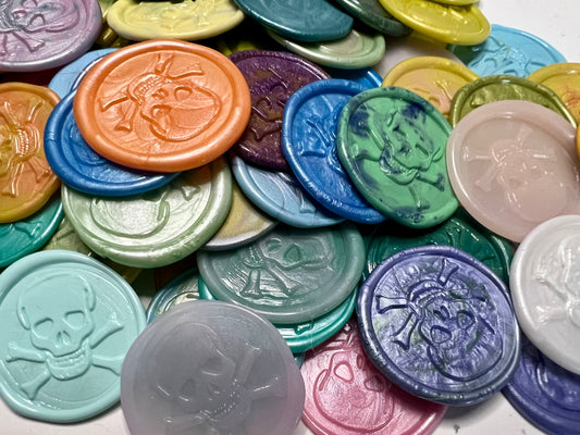 Skull and crossbones wax seals crafted from beeswax-paraffin blend with peel-and-stick convenience.