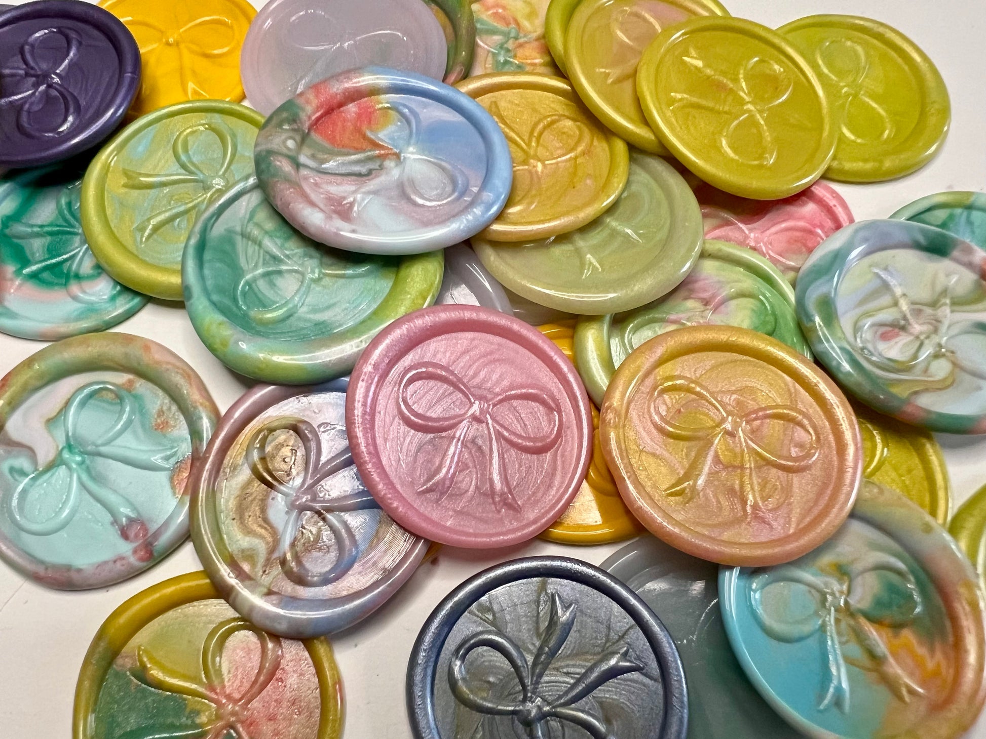 Delicate bow wax seal stickers created by Rochambeau Home in various colors.