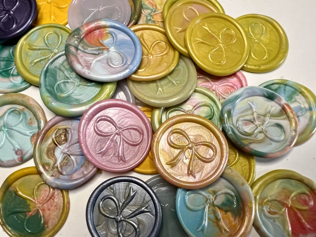 Close up view of the Elegant Bow wax seal stickers in a variety of colors for any occasion