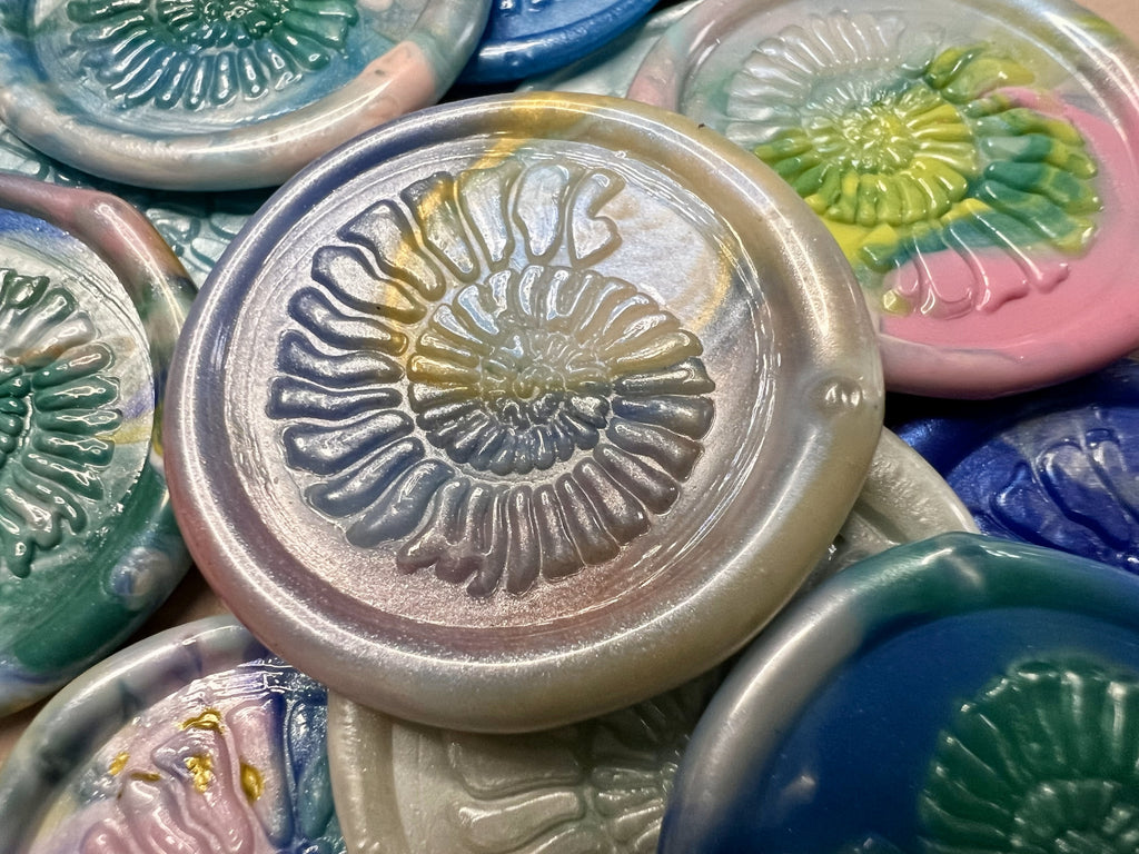 Set of glossy wax seal stickers featuring intricate ammonite fossil designs in earthy tones