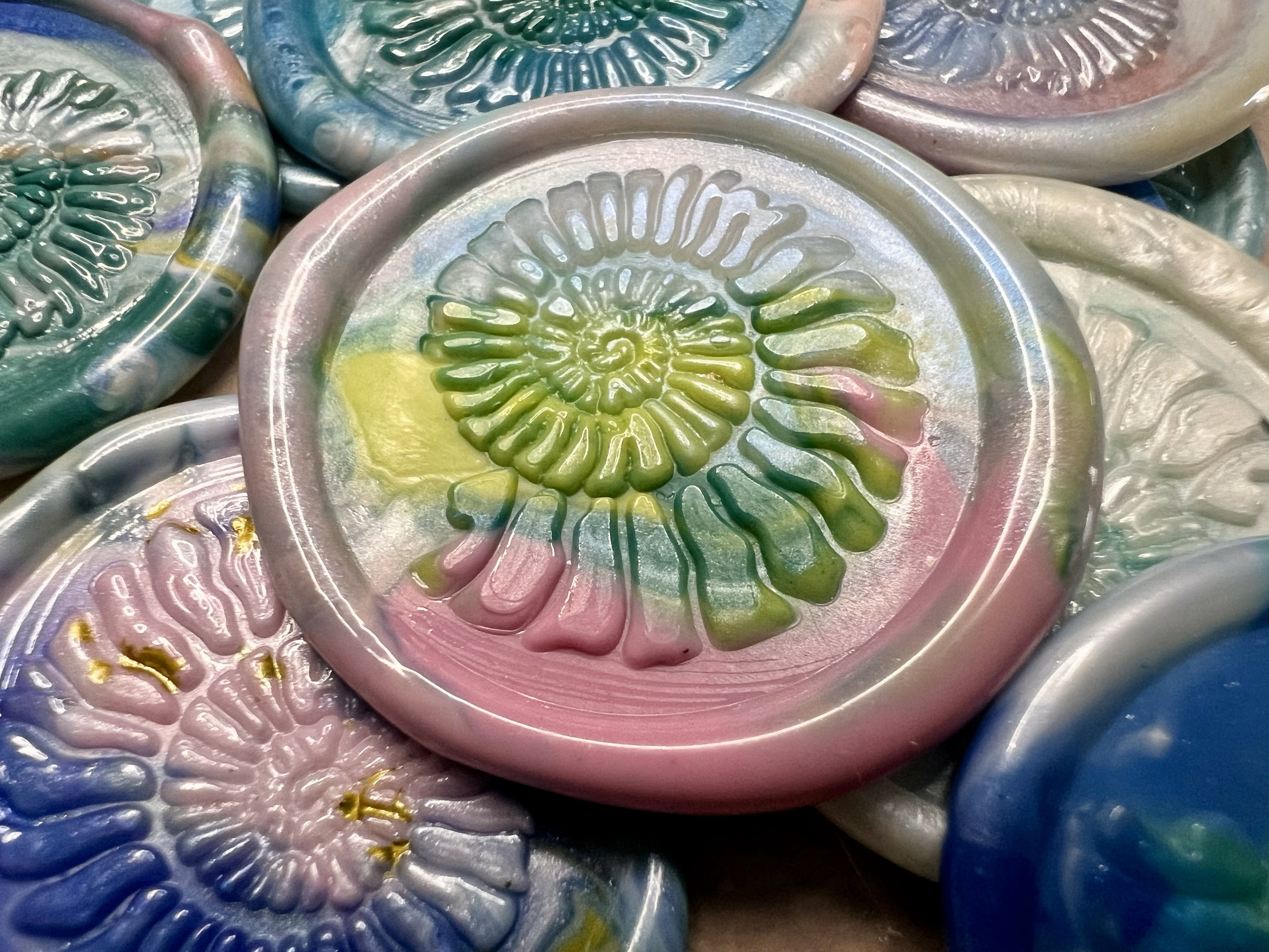 Ancient-inspired wax seals with ammonite spirals, perfect for elevating invitations or gifts