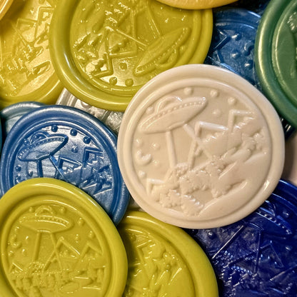 Close-up of embossed flying saucer design in multicolor wax seal stickers created by Rochambeau Home.