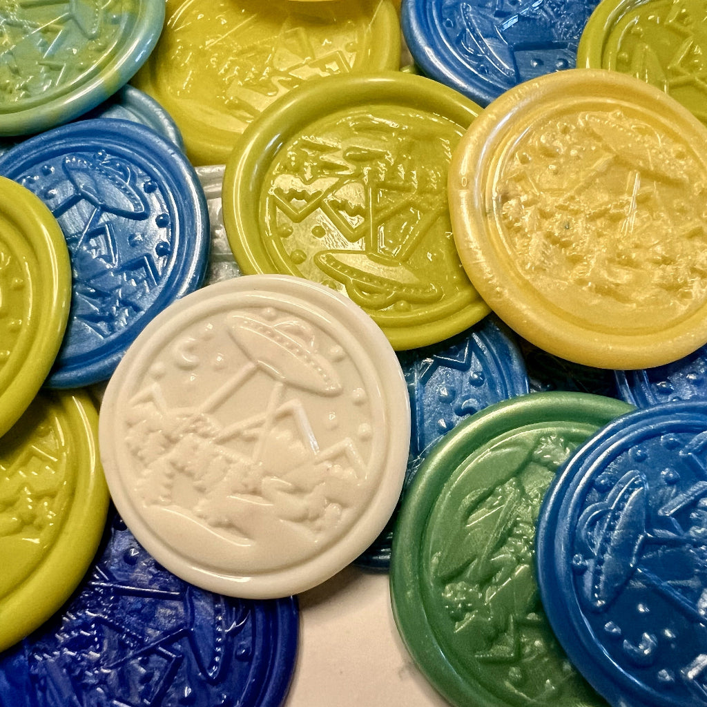 Colorful wax seal stickers with embossed UFO and space designs created by Rochambeau Home on a white background