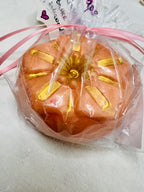 Close-up of textured soap bar with visible loofah and creamy finish