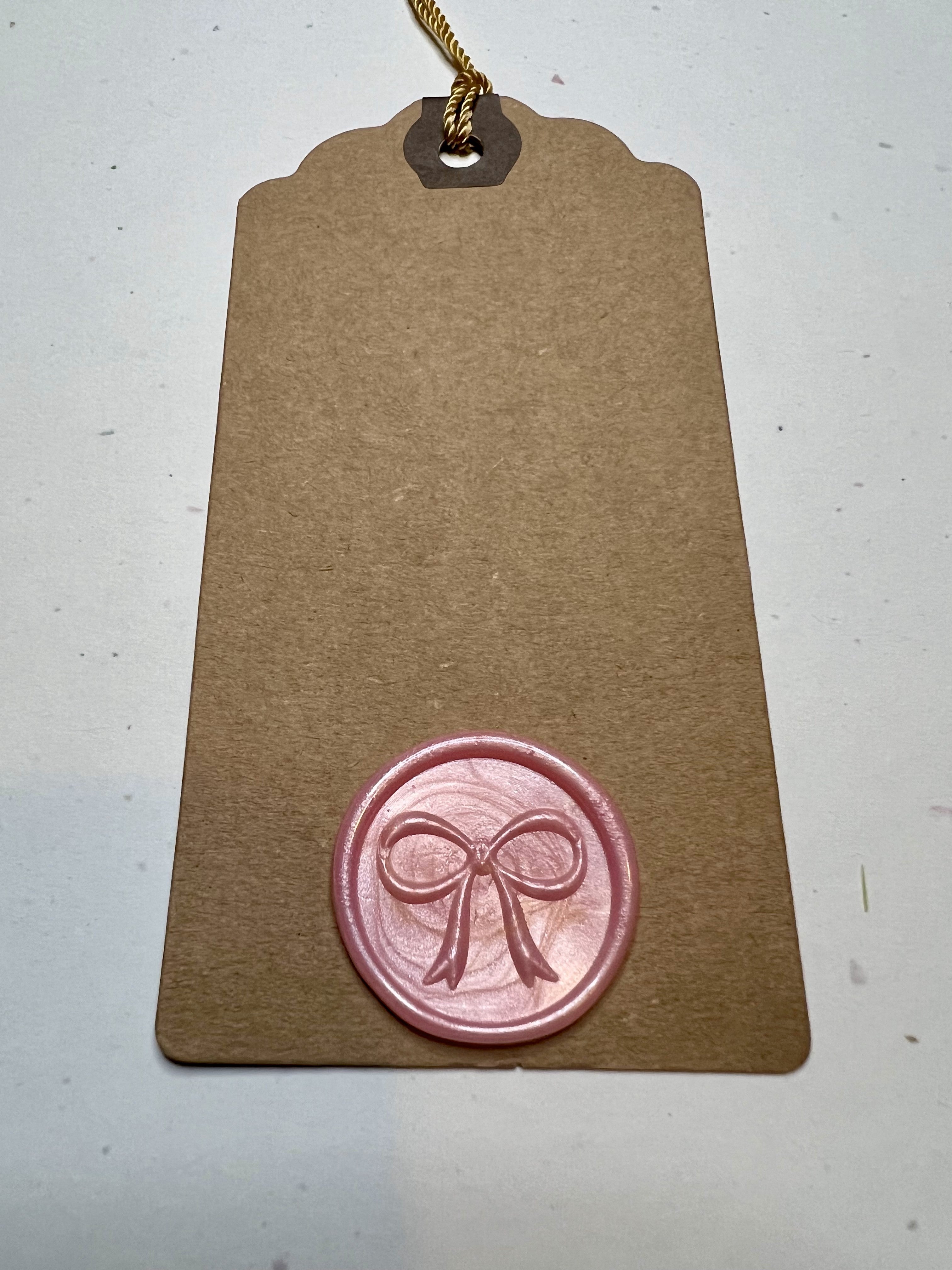 Handcrafted wax seal gift tags with a refined bow design, adding a special touch to any gift.