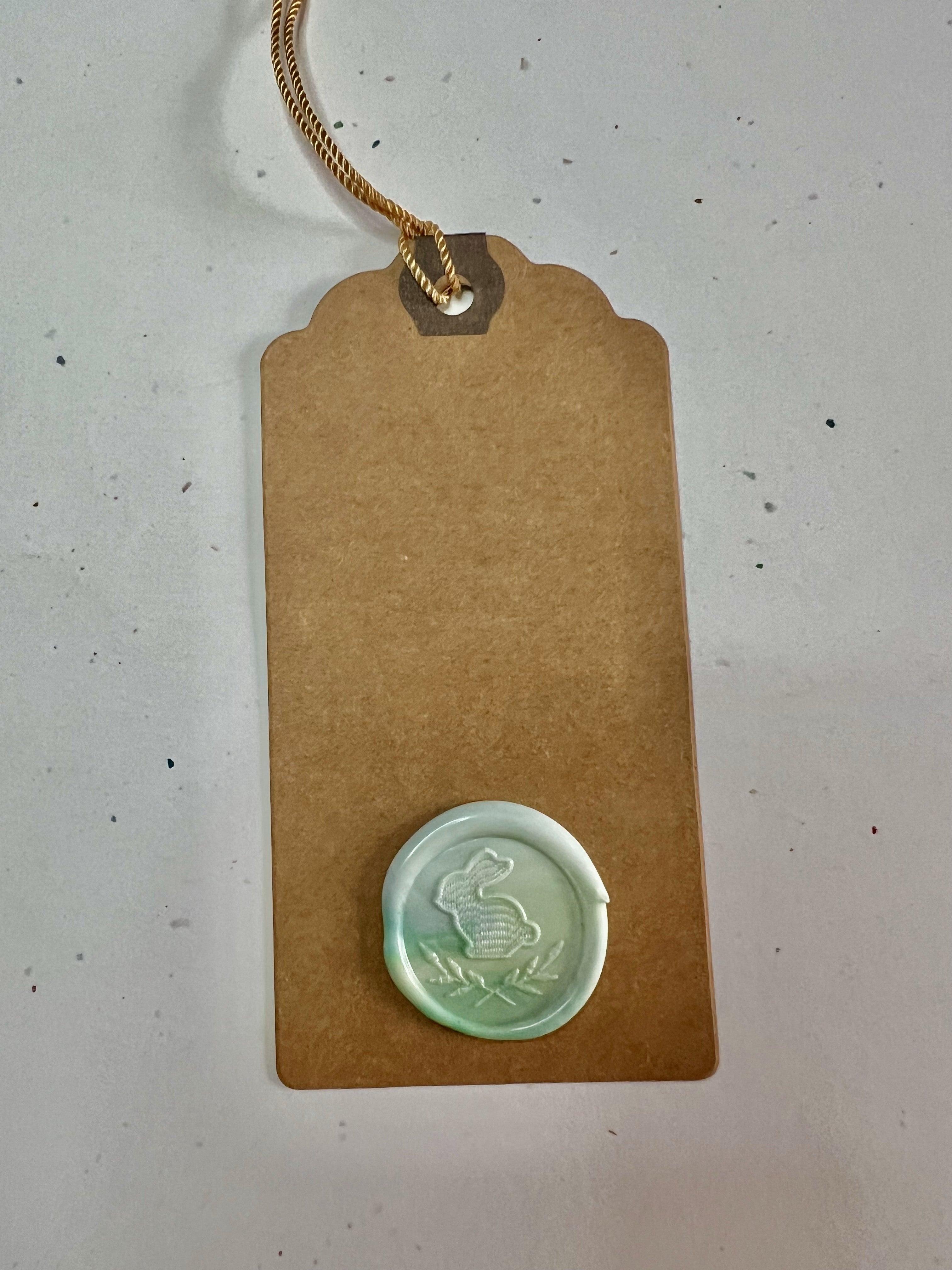 Rustic-chic Easter tags with pressed bunny and flower wax seals, ideal for spring gift wrapping.