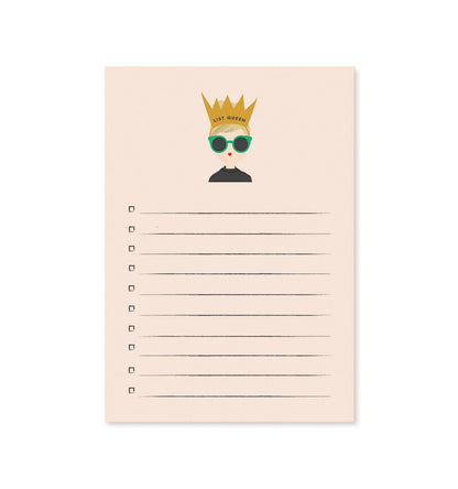 Notepad with a decorative cover featuring a person wearing a crown and sunglasses, on a white background