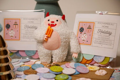 Christmas Yeti eating ice cream with Holiday wax seals surrounding it