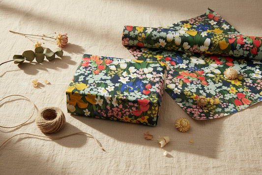 Meadow wrapping paper and sheets displayed on a neutral textured background and natural elements