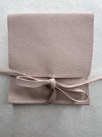 Close up view of the Mother of Pearl bracelet in suede packaging