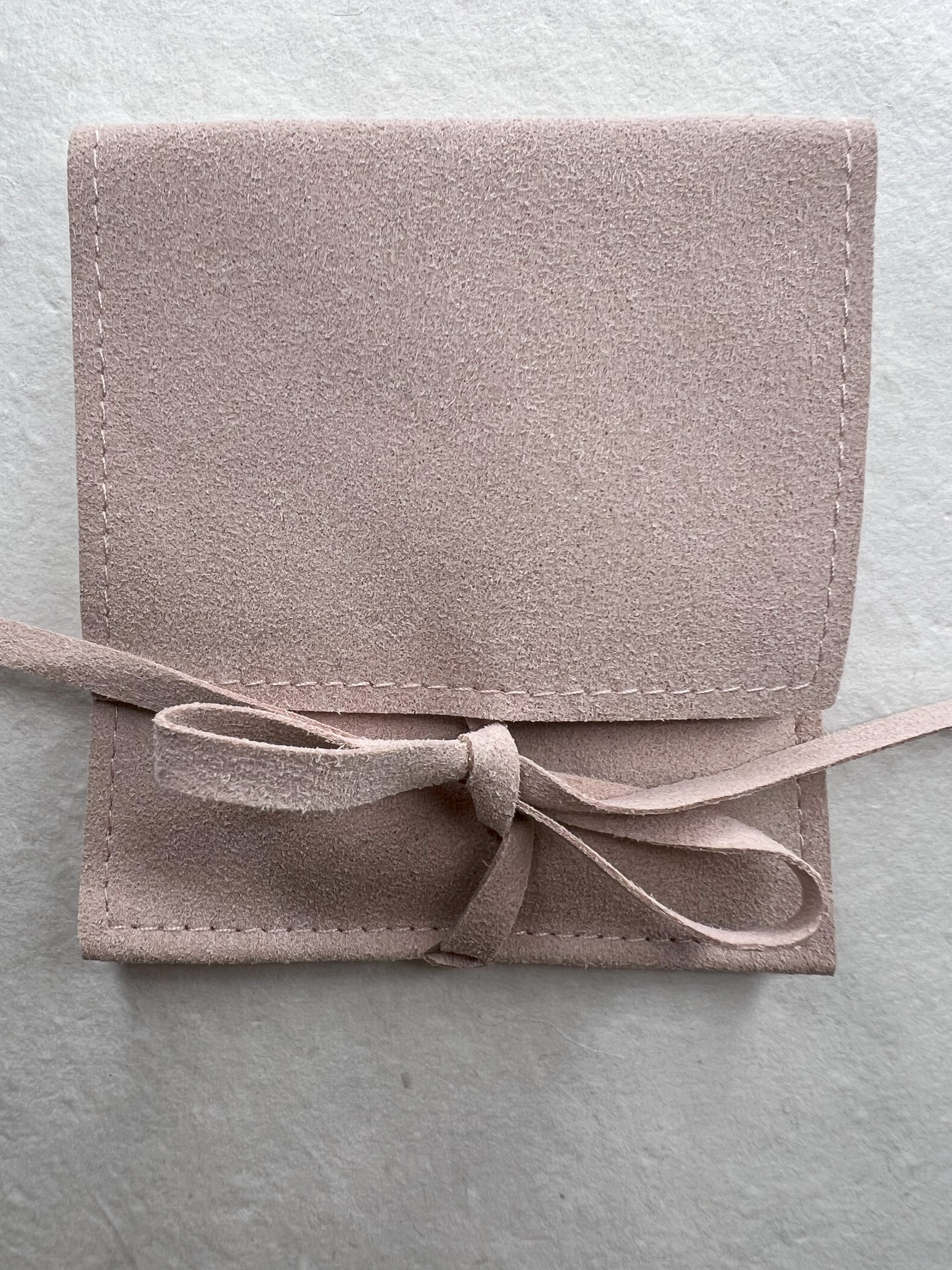 Close up view of the Mother of Pearl bracelet in suede packaging