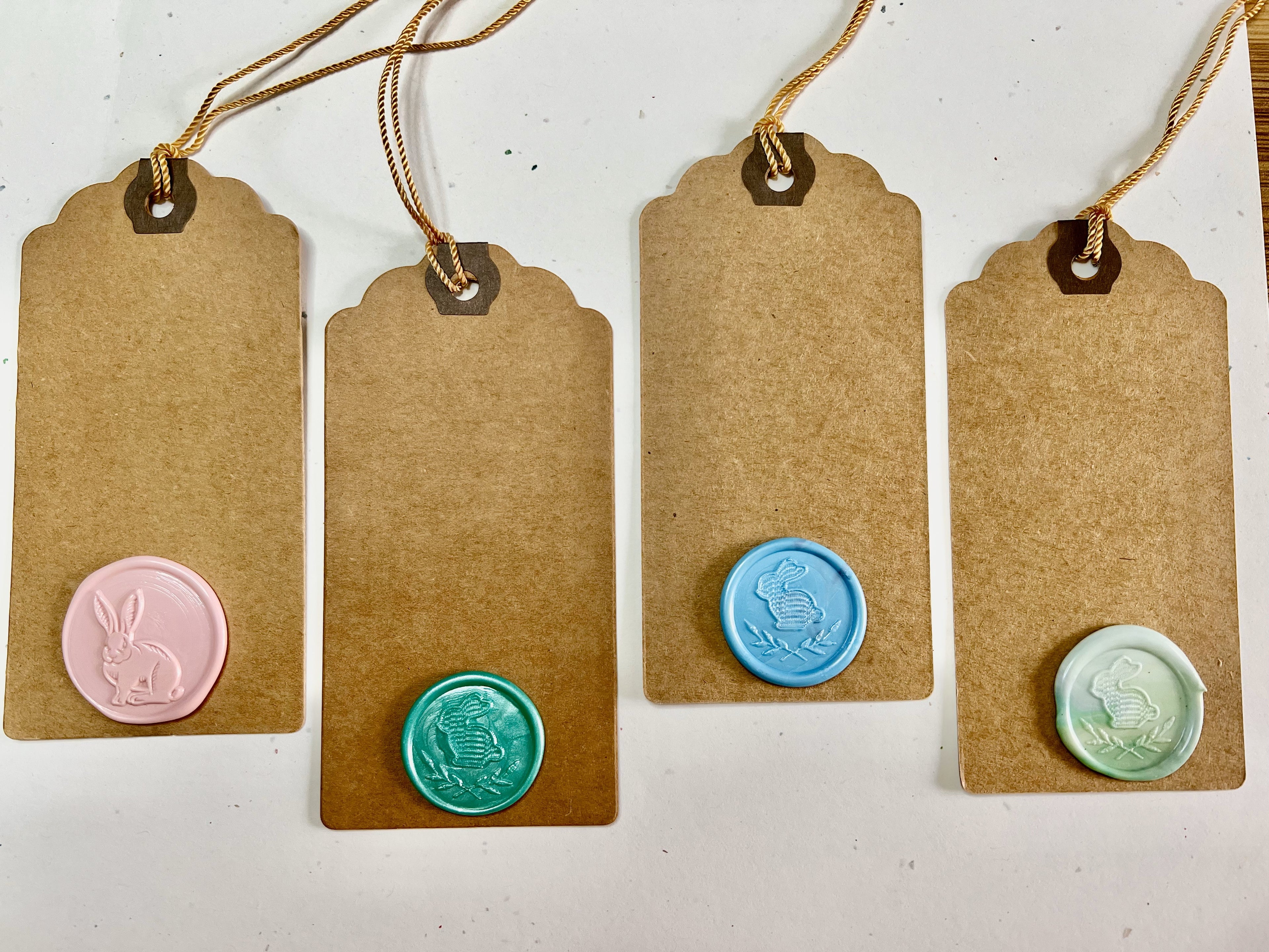 Earth-toned Easter tags with detailed wax seals, perfect for wrapping or decorating baskets.